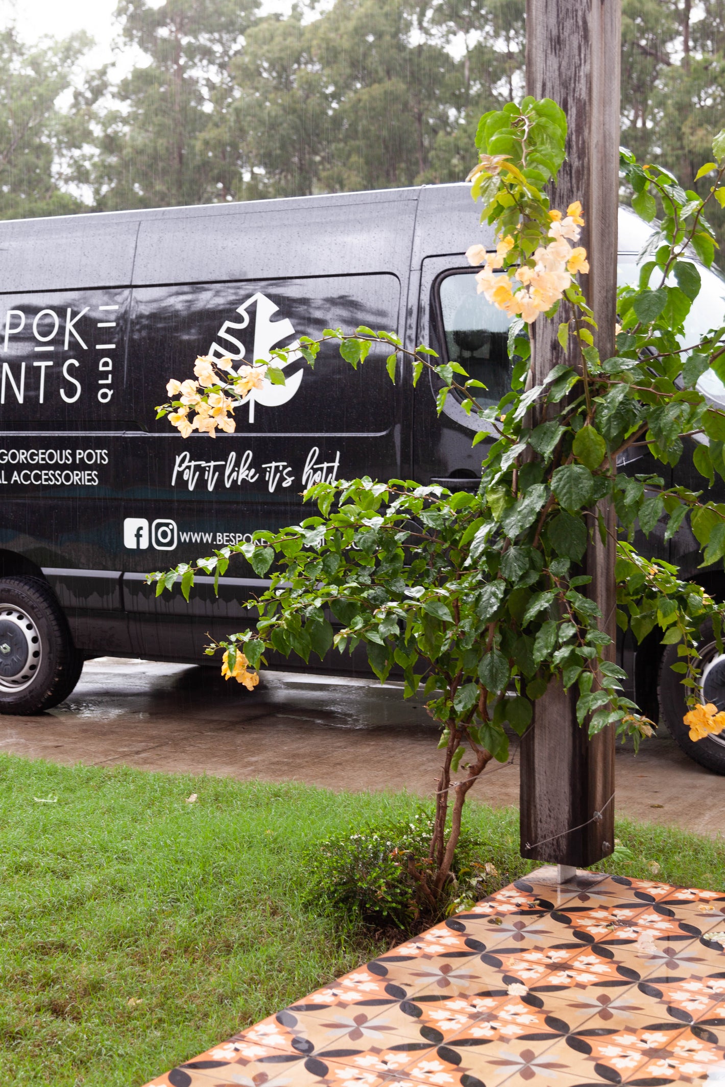 Picture of our Black Delivery Van featuring our logo in white stickers